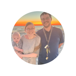 man, woman, and baby in sunset picture